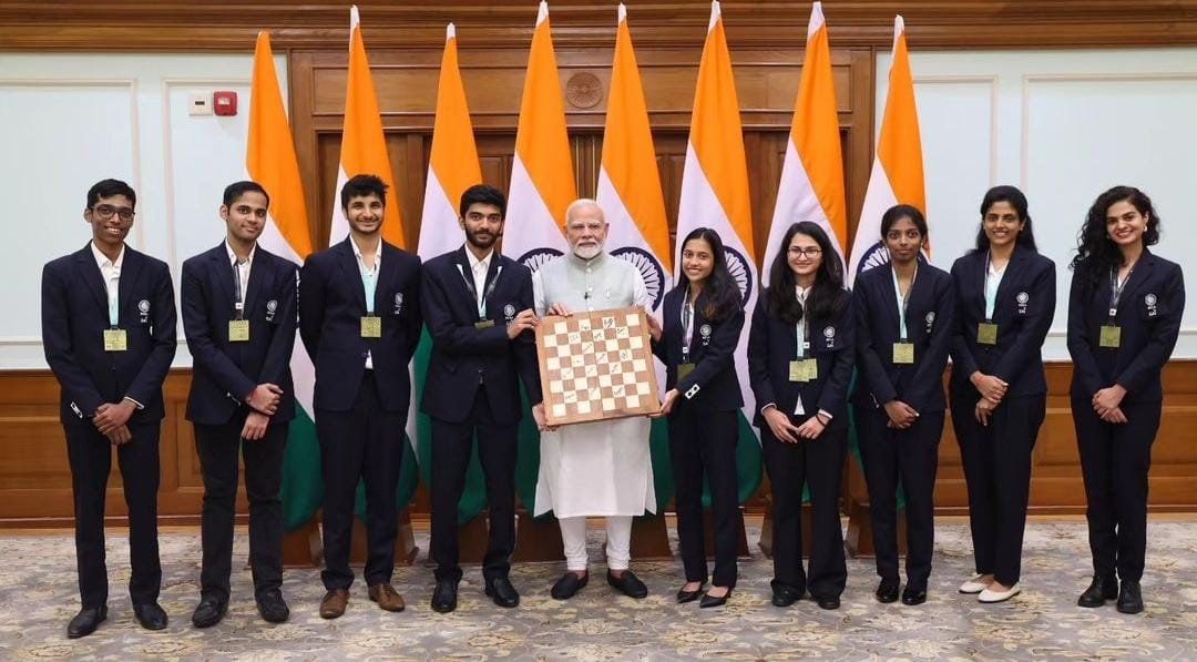 Prime Minister Narendra Modi being presented a chessboard signed by the 45th FIDE Chess Olympiad 2024 winning team members, at his residence in New Delhi on Wednesday