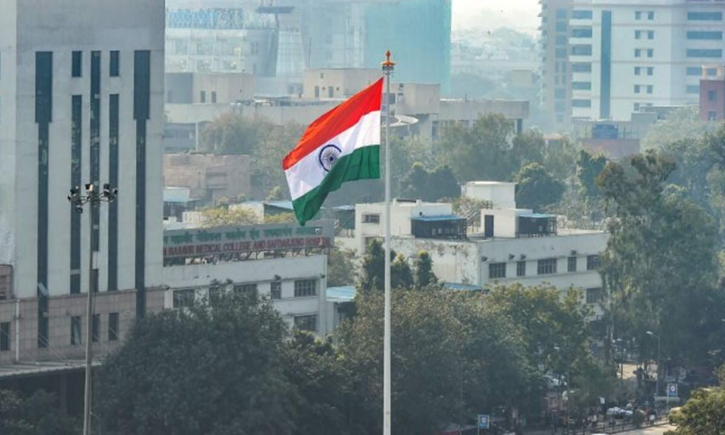 India’s flag stands tall against a city skyline, symbolizing hope amid growing pollution challenges.