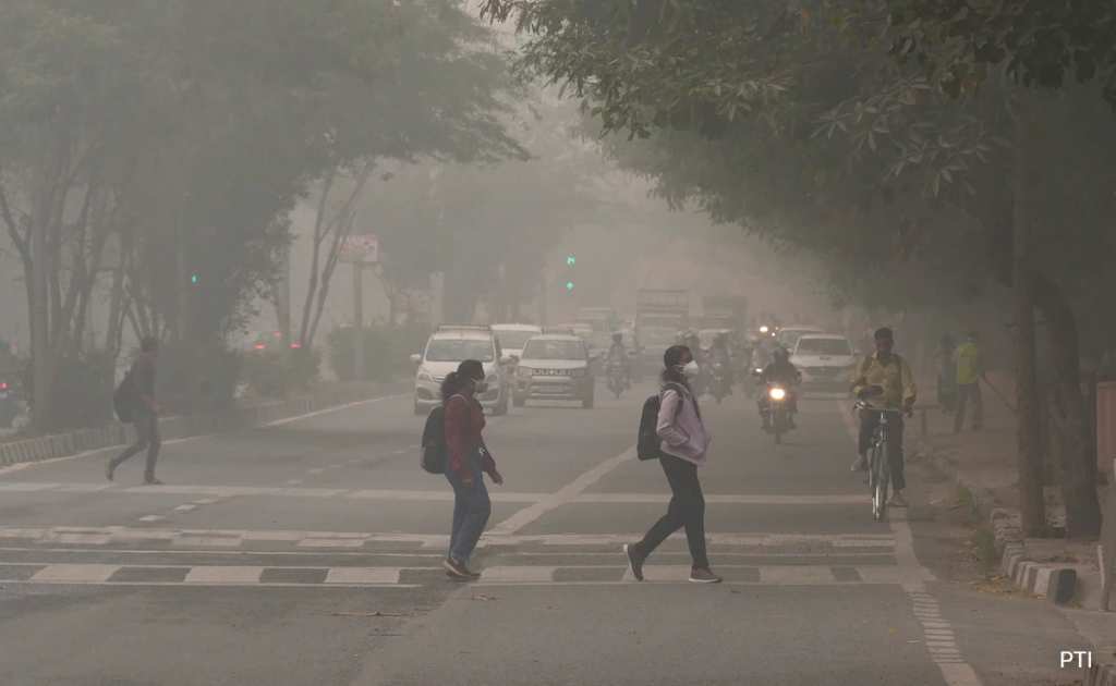 A pedestrian wears a mask as AQI levels in Delhi hit hazardous levels, surpassing 450.